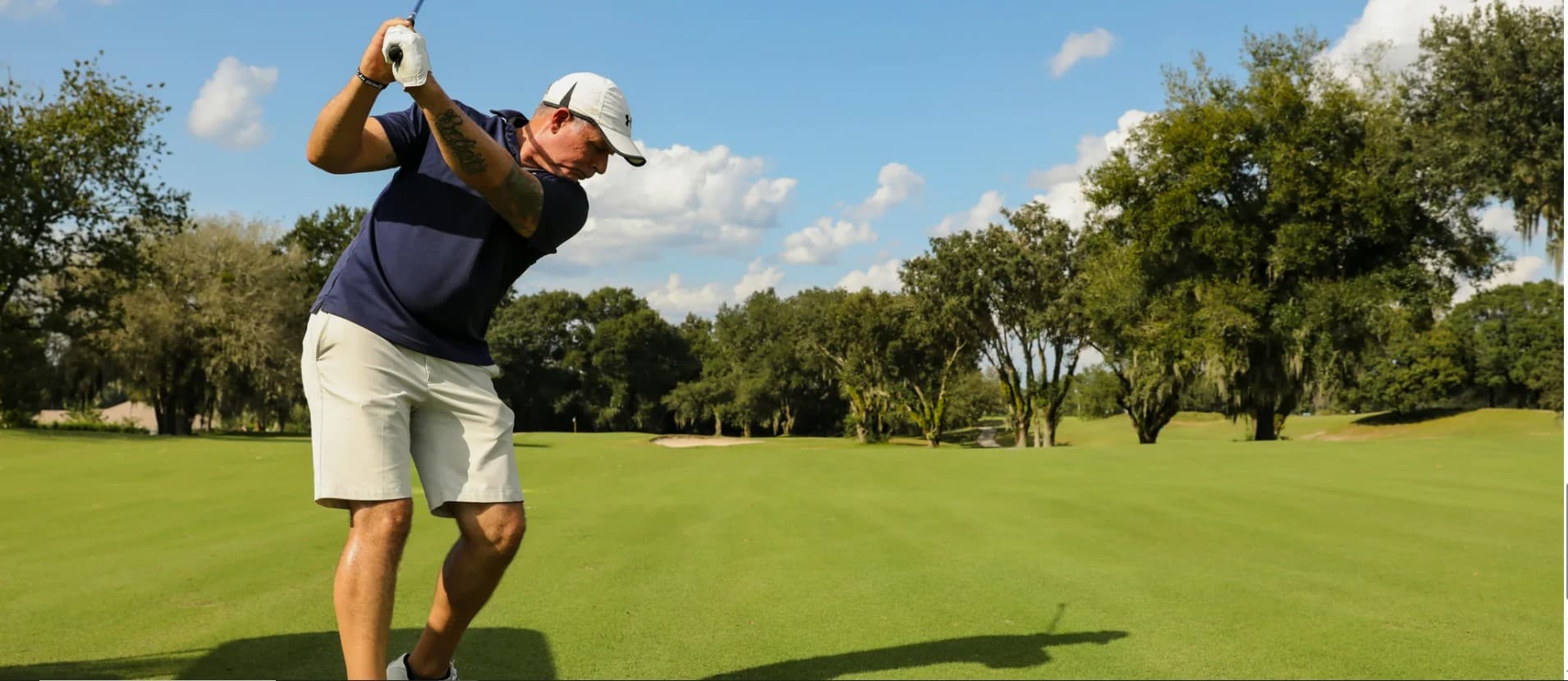 Golfer completing a full swing on an MBN fairway